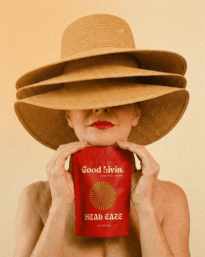 Two people in sauna hats with a warm orange light drifting across the photo